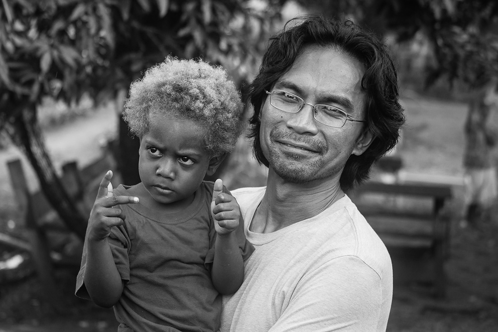 Albert, a local boy on Ulawa Island, in the arms of his namesake, biologist Dr. Al Uy.