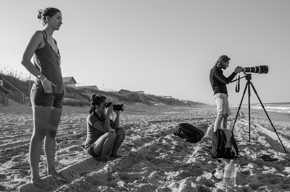 Neil films the North Carolina shore with Scientists with Stories workshop participants Eleanor Caves and Mariko Weber. Photo by Lomax Boyd.