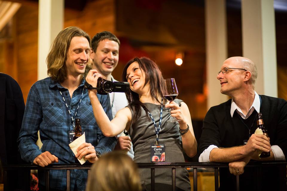 Carin Bondar shows Neil footage from the Science Online "Gangnam Style" parody video while Brian Krueger and Alex Wild look on. Photo by Russ Creech.